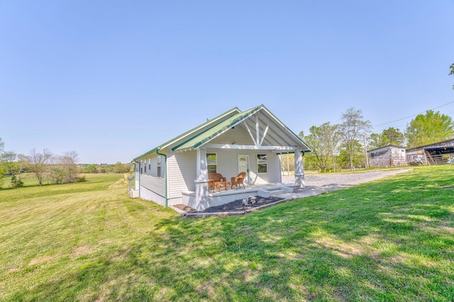 back of property with a lawn