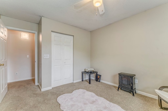 1962 Meadowbrook Cir, Dalton, GA 30720 - unfurnished bedroom with a wood stove, carpet, a ceiling fan, a closet, and a textured ceiling