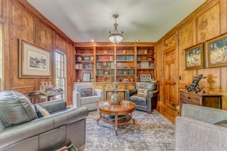 1603 Habersham Way, Dalton, GA 30720 - living area with crown molding, wooden walls, and built in shelves