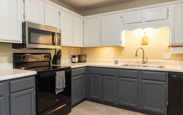 kitchen featuring white cabinetry, sink, and black appliances