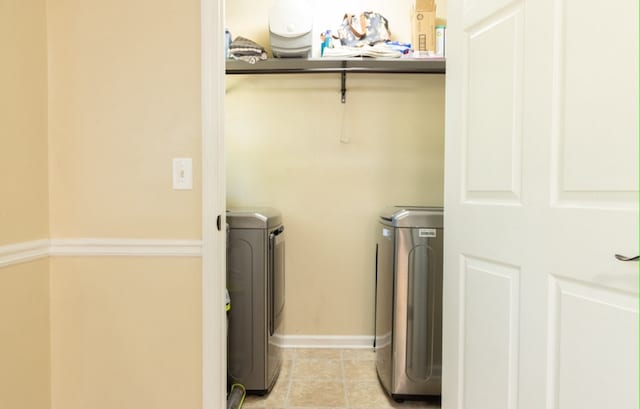 washroom featuring independent washer and dryer and light tile patterned flooring