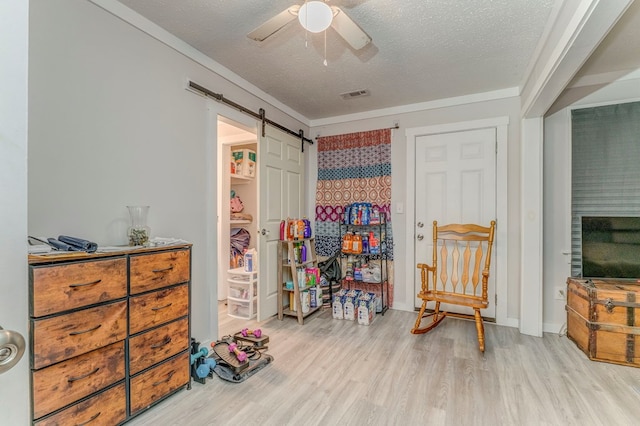375 Weber Rd, Crandall, GA 30711 - sitting room with wood finished floors, a textured ceiling, ceiling fan, and a barn door