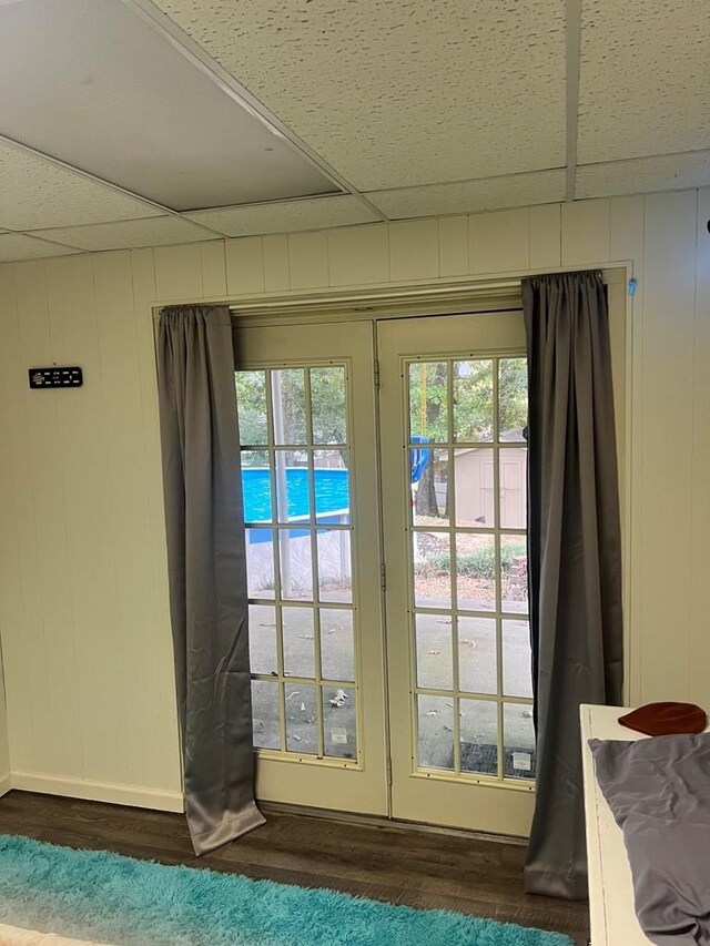doorway to outside featuring dark hardwood / wood-style floors and a paneled ceiling