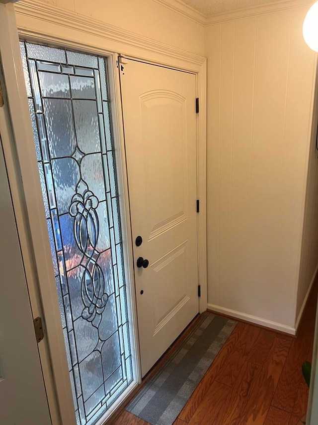 entrance foyer with crown molding and dark hardwood / wood-style flooring