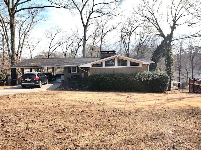 ranch-style house featuring a carport