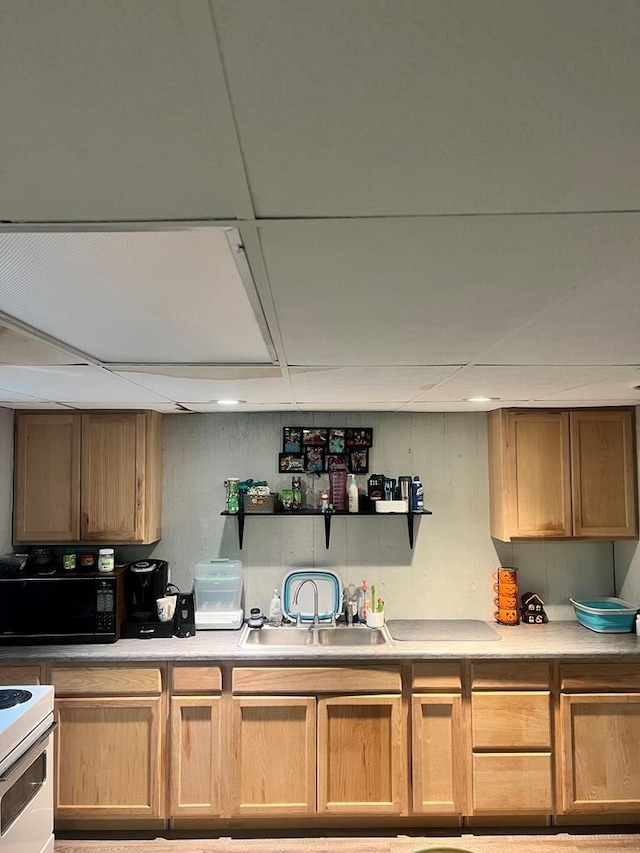 kitchen with electric range, sink, and a drop ceiling