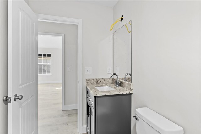 519 Abigail St, Dalton, GA 30721 - bathroom featuring vanity, toilet, wood finished floors, and baseboards