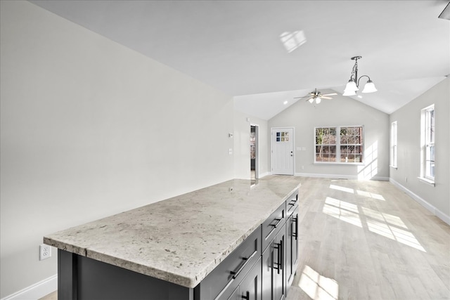 519 Abigail St, Dalton, GA 30721 - kitchen featuring hanging light fixtures, ceiling fan, baseboards, lofted ceiling, and a chandelier