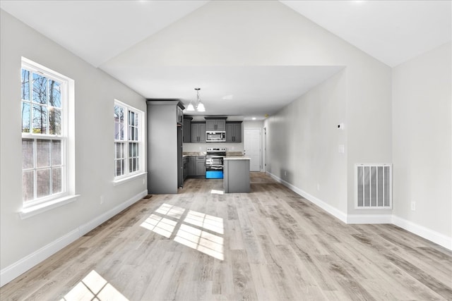 519 Abigail St, Dalton, GA 30721 - kitchen featuring appliances with stainless steel finishes, a chandelier, light wood-style flooring, vaulted ceiling, and open floor plan
