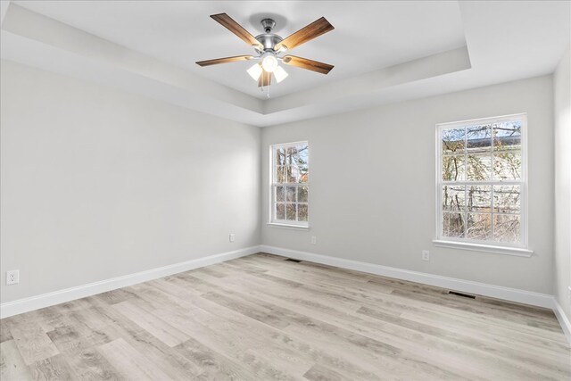 519 Abigail St, Dalton, GA 30721 - empty room with a raised ceiling, light wood-style floors, baseboards, and a ceiling fan
