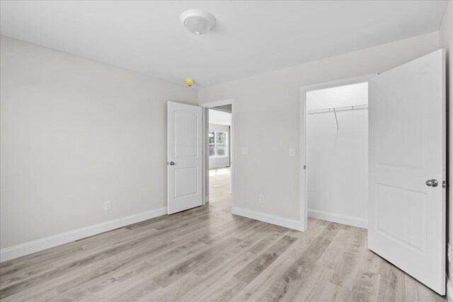 519 Abigail St, Dalton, GA 30721 - unfurnished bedroom with light wood finished floors, baseboards, and a closet