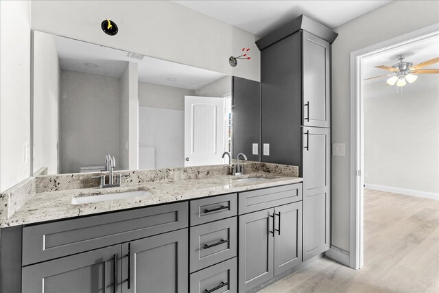 519 Abigail St, Dalton, GA 30721 - bathroom with double vanity, wood finished floors, a ceiling fan, and baseboards