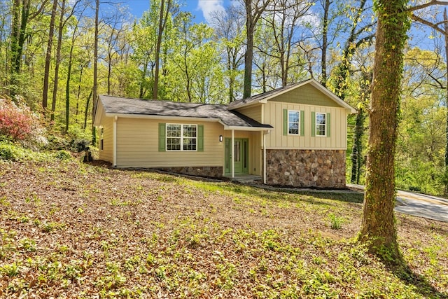 tri-level home with board and batten siding and stone siding