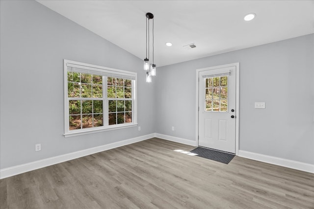 unfurnished dining area featuring recessed lighting, dark wood-type flooring, baseboards, and vaulted ceiling