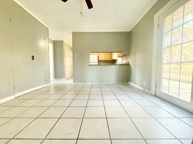 unfurnished living room featuring light tile patterned flooring, ceiling fan, and a textured ceiling