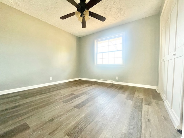 unfurnished room with hardwood / wood-style flooring, ceiling fan, and a textured ceiling