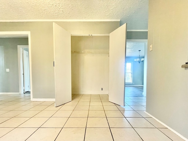 unfurnished bedroom featuring light tile patterned flooring, a closet, and a textured ceiling