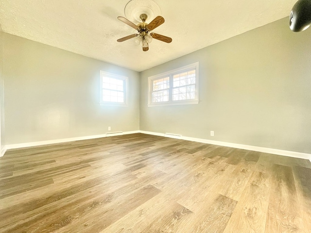 spare room with ceiling fan, hardwood / wood-style floors, and a textured ceiling