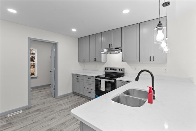 kitchen featuring pendant lighting, sink, gray cabinetry, and electric stove