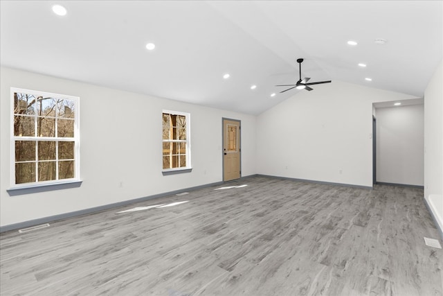 unfurnished living room with vaulted ceiling, ceiling fan, and light wood-type flooring