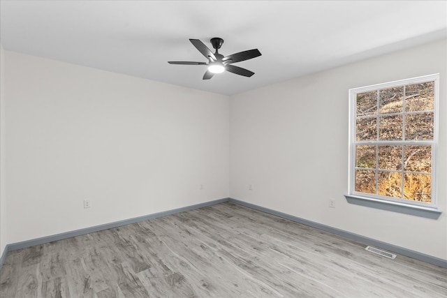 unfurnished room with ceiling fan and light wood-type flooring