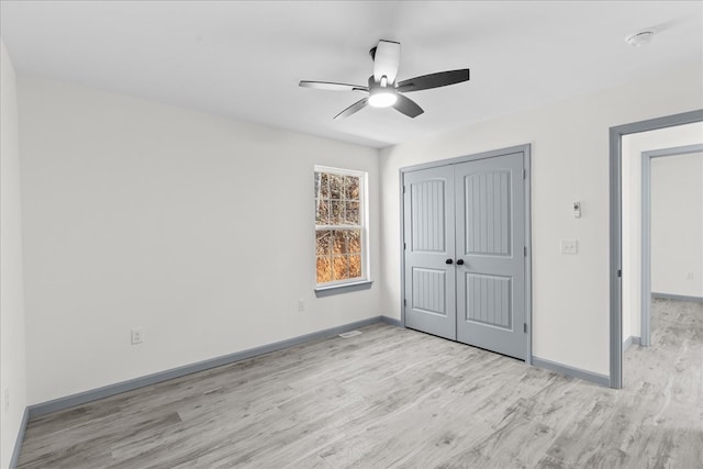 unfurnished bedroom with a closet, ceiling fan, and light hardwood / wood-style flooring