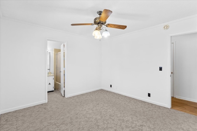 carpeted empty room featuring ornamental molding and ceiling fan