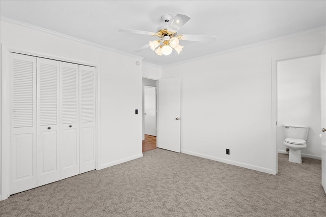 unfurnished bedroom with crown molding, light carpet, and a closet