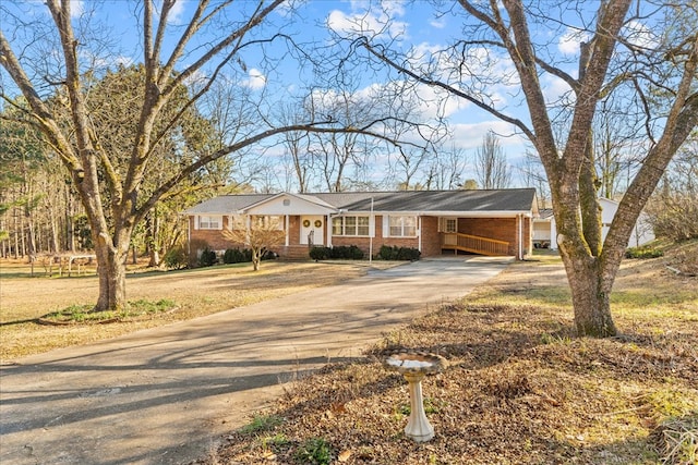 single story home featuring a carport