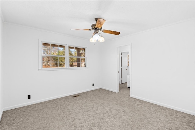 unfurnished room with ornamental molding, light colored carpet, and ceiling fan