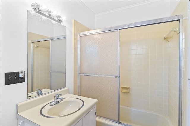 bathroom featuring vanity, bath / shower combo with glass door, and ornamental molding