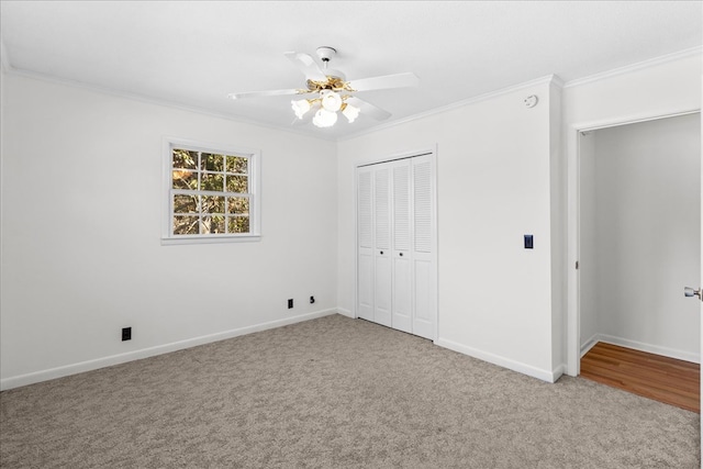 unfurnished bedroom with ornamental molding, light carpet, ceiling fan, and a closet