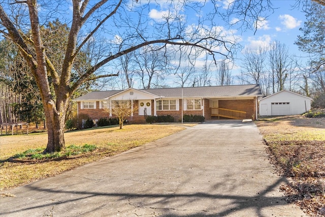 single story home featuring a garage, an outbuilding, and a front lawn