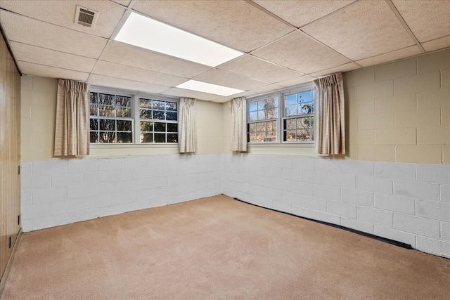 carpeted spare room with a paneled ceiling