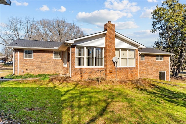 rear view of house featuring a lawn