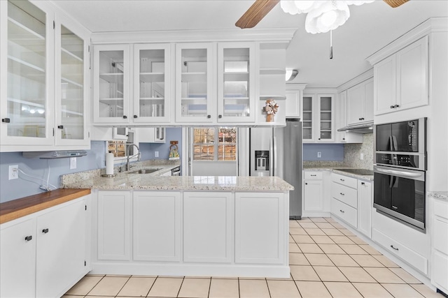 kitchen featuring white cabinetry, sink, kitchen peninsula, and appliances with stainless steel finishes