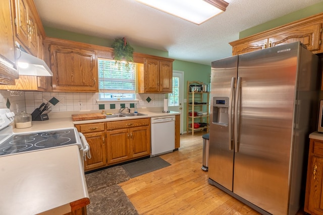639 Mount View Dr, Tunnel Hill, GA 30755 - kitchen featuring white appliances, a sink, light wood-type flooring, under cabinet range hood, and backsplash