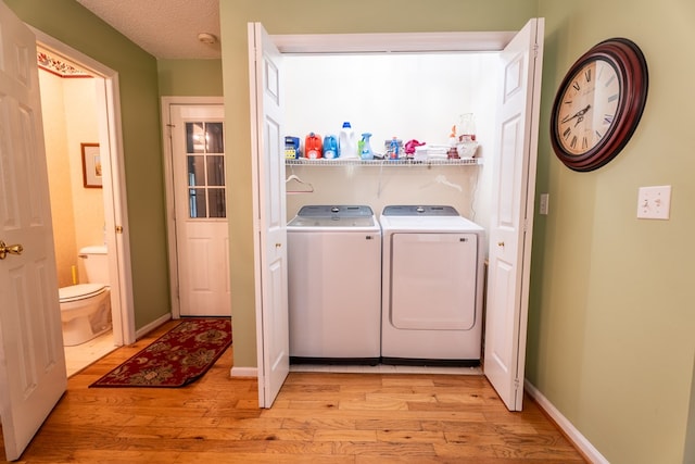 639 Mount View Dr, Tunnel Hill, GA 30755 - laundry room featuring light wood-style floors, washer and dryer, and baseboards