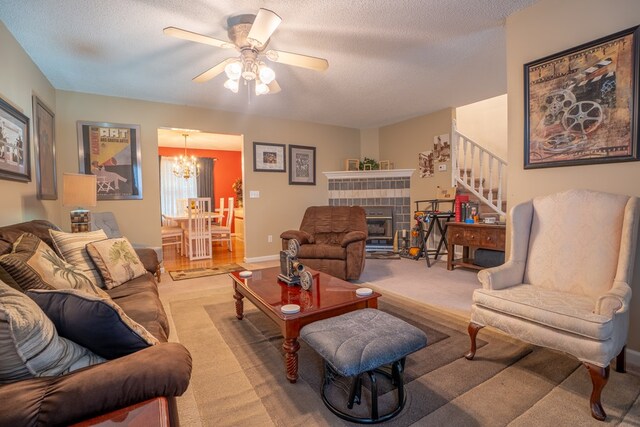 639 Mount View Dr, Tunnel Hill, GA 30755 - living area featuring stairs, a textured ceiling, a chandelier, a ceiling fan, and a fireplace