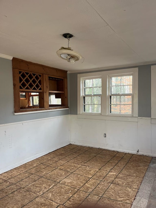 spare room with crown molding