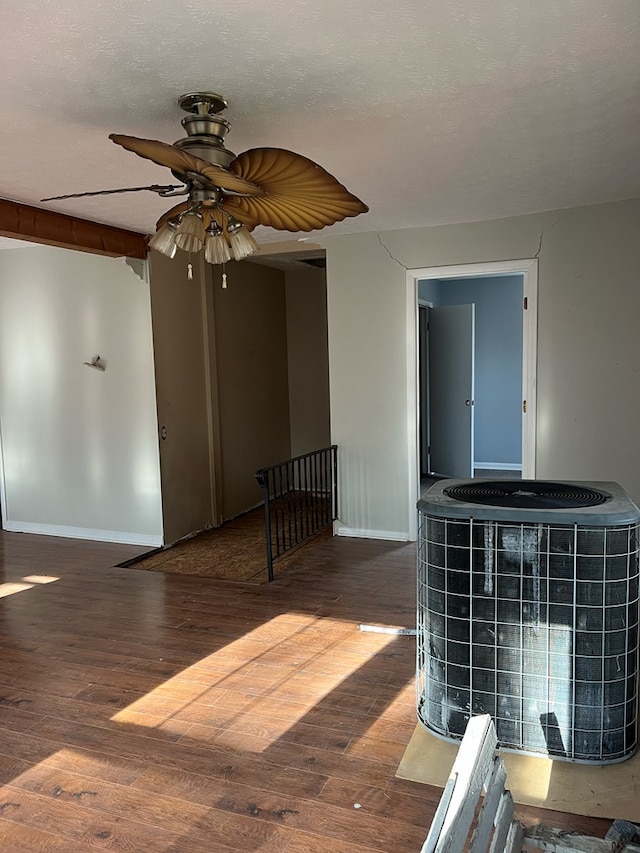 interior space with baseboards, ceiling fan, and hardwood / wood-style flooring