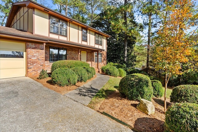 608 Brookview Ln, Dalton, GA 30720 - tudor home featuring brick siding, driveway, board and batten siding, and an attached garage