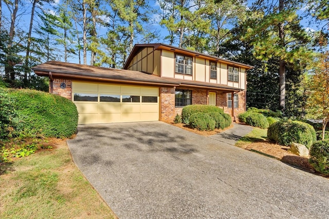 608 Brookview Ln, Dalton, GA 30720 - tudor-style house featuring concrete driveway, a garage, brick siding, and board and batten siding