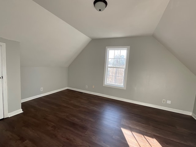 bonus room featuring dark wood-type flooring and lofted ceiling