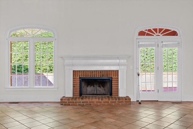 2001 Eagle Point Dr, Dalton, GA 30720 - unfurnished living room featuring healthy amount of natural light, a brick fireplace, and light tile patterned flooring