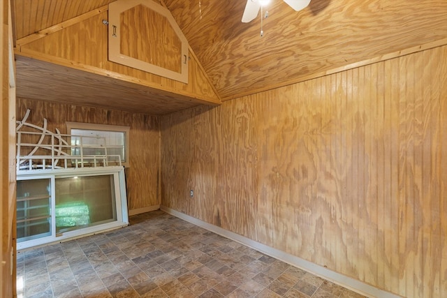 2001 Eagle Point Dr, Dalton, GA 30720 - empty room with wood walls, vaulted ceiling, ceiling fan, stone finish flooring, and baseboards