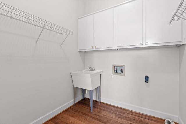 2001 Eagle Point Dr, Dalton, GA 30720 - washroom featuring washer hookup, baseboards, wood finished floors, and cabinet space