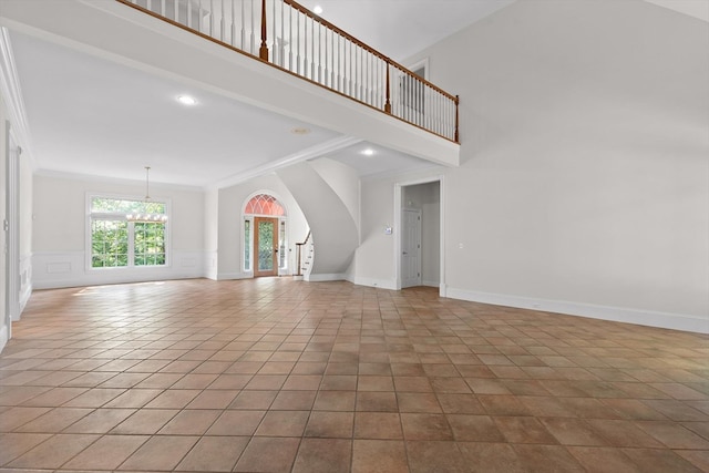 2001 Eagle Point Dr, Dalton, GA 30720 - unfurnished living room featuring a chandelier, crown molding, a high ceiling, tile patterned floors, and baseboards