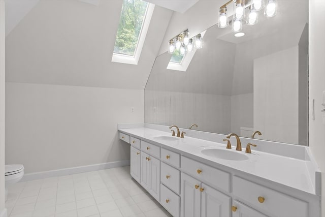 2001 Eagle Point Dr, Dalton, GA 30720 - bathroom featuring a skylight, double vanity, toilet, baseboards, and lofted ceiling