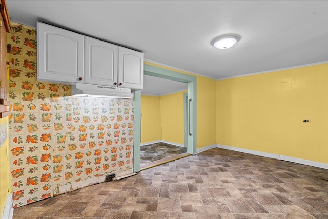 1098 Mount Vernon Rd, Tunnel Hill, GA 30755 - kitchen featuring under cabinet range hood, white cabinets, stone finish floors, baseboards, and crown molding